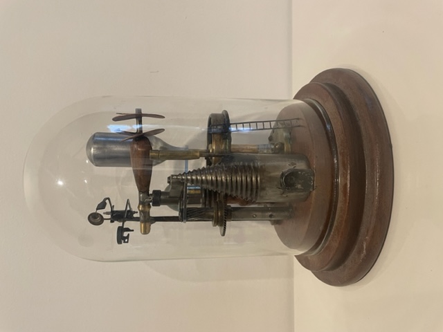 An abstract sculpure of various components that depict outdoor living encased in glass