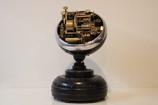 A brass sculpture made using repurposed car parts