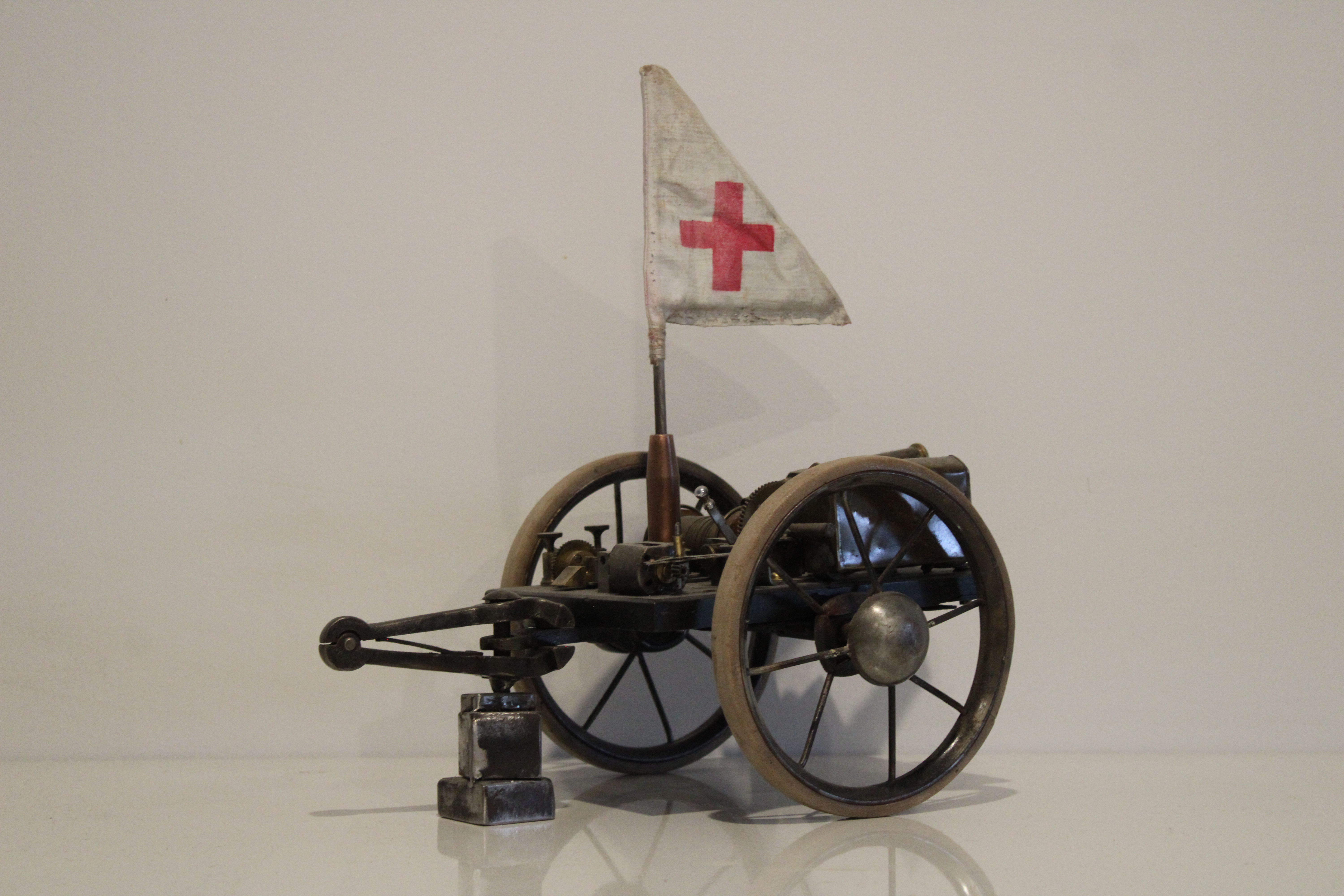 A sculpture of a wagon made using electrical parts and various components