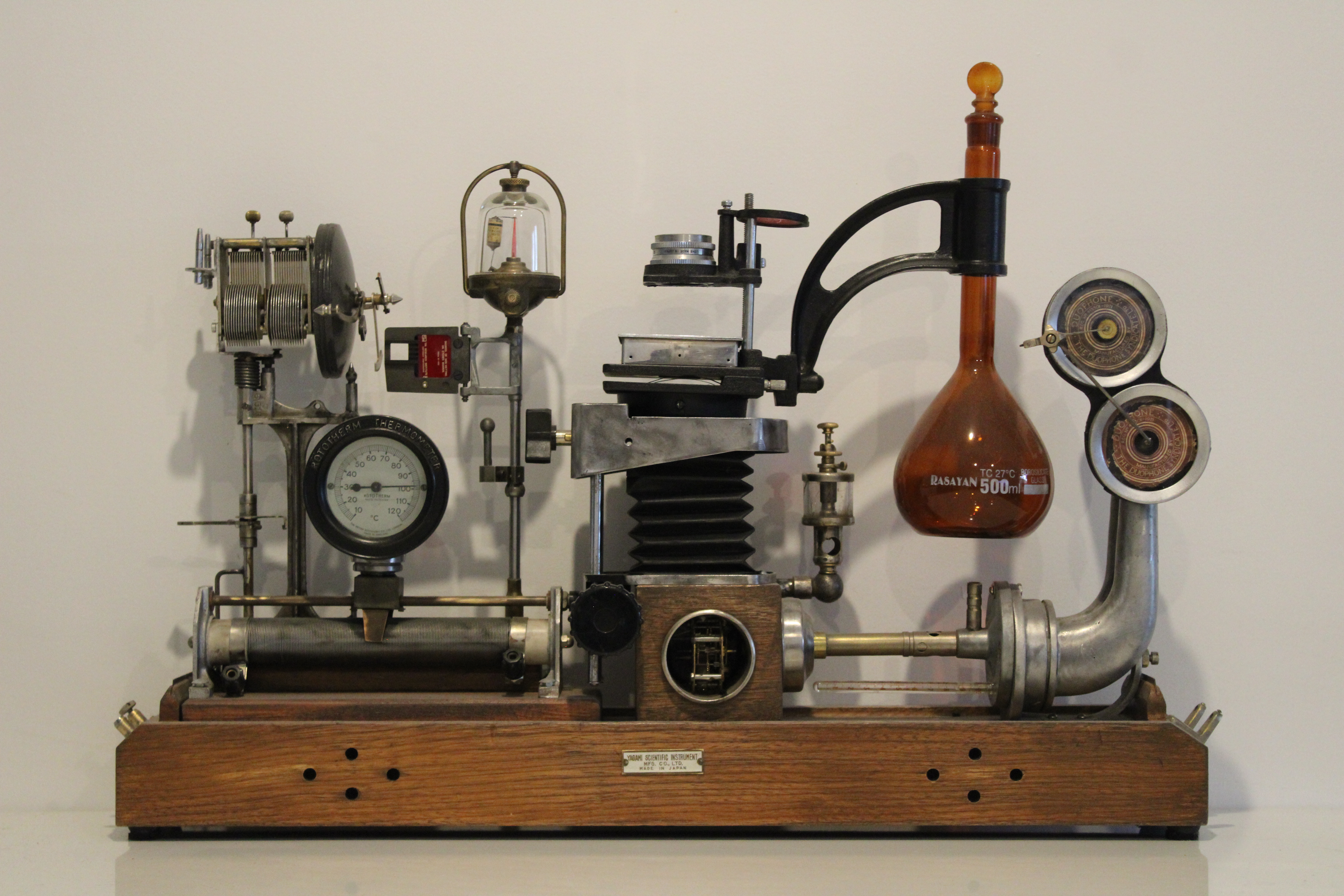 A sculpture crafted from laboratory and electrical components, depicting a scientific and mechanical instrument.